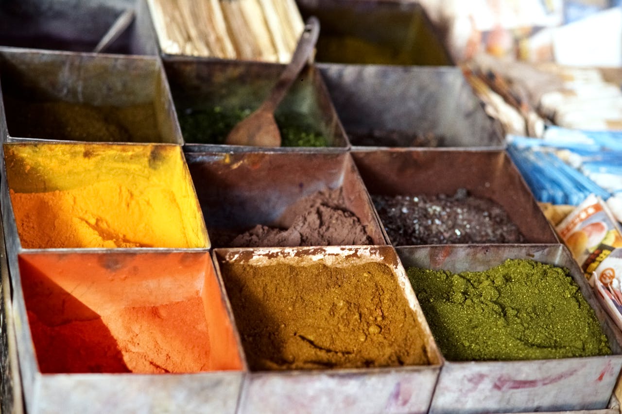 A vibrant display of spices in a traditional Pakistani market stall.
